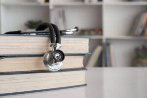 Medical books and stethoscope representing reliable health research sources